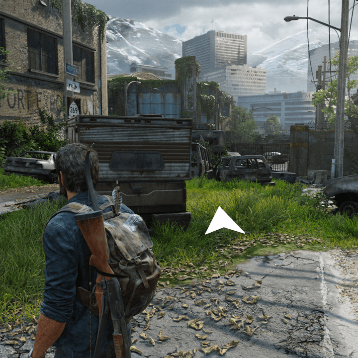 A white arrow shows Joel where to go in The Last of Us Part I.