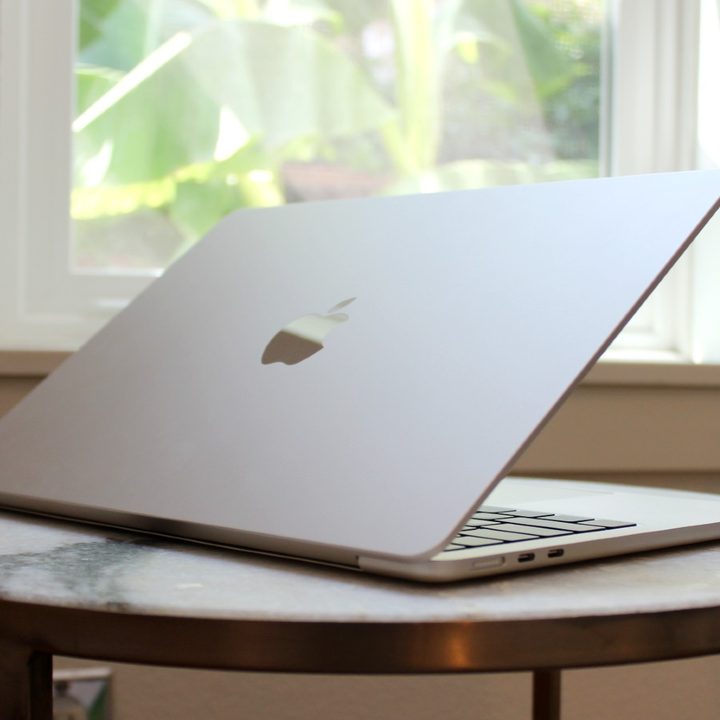 The MacBook Air on a table in front of a window.