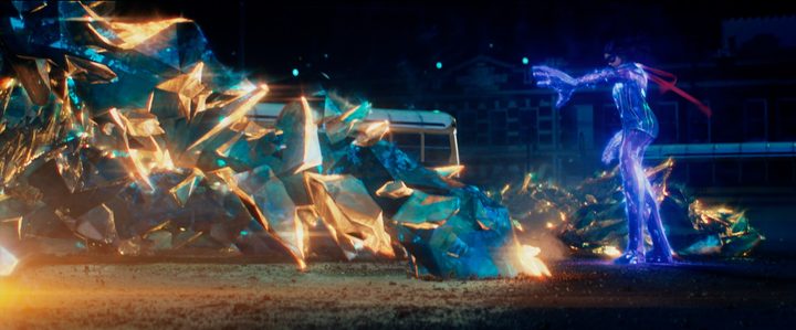 Giant-size Ms. Marvel pushes against waves of crystalline energy in a scene from the series.