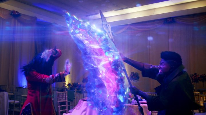 Ms. Marvel defends herself with a shield of crystalline hard light.
