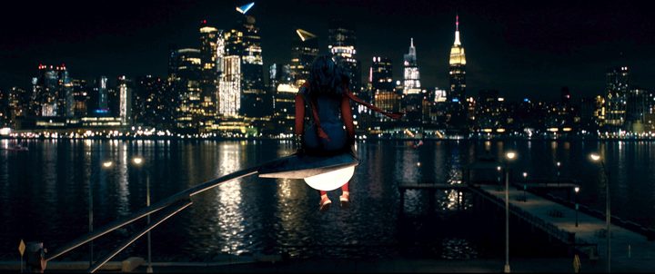 Ms. Marvel sits on a lamppost looking at Manhattan.