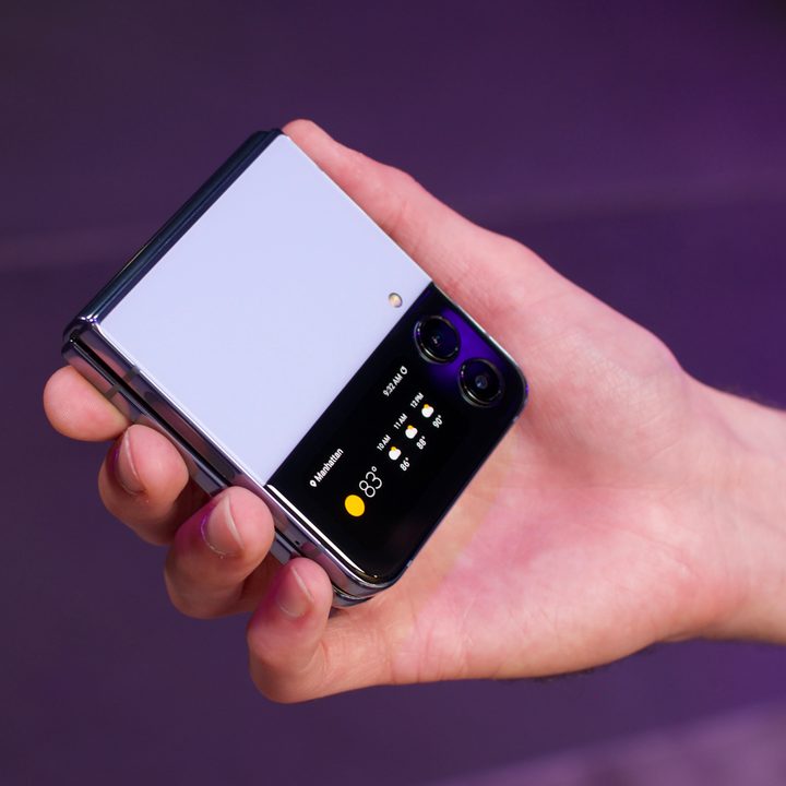 A hand holding the Samsung Galaxy Z Flip 4.