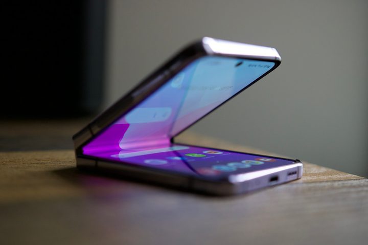The Samsung Galaxy Z Flip 4, half-opened and sitting on a table.