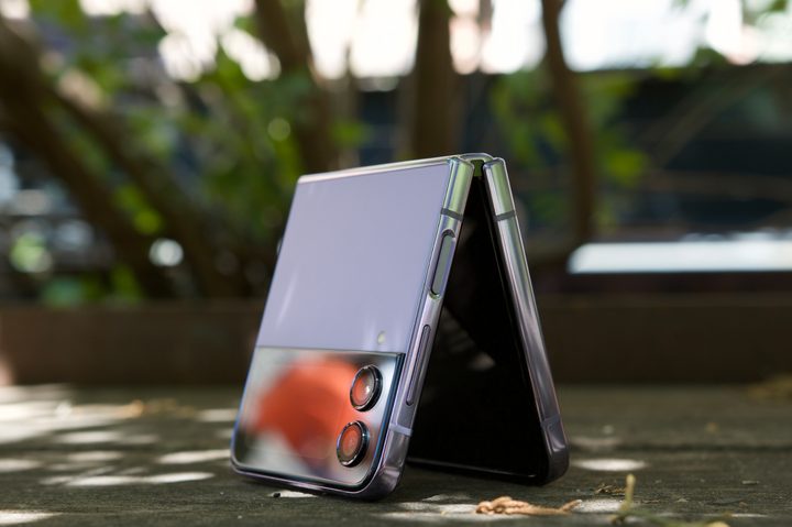 The Samsung Galaxy Z Flip 4, standing upside down while half opened up.
