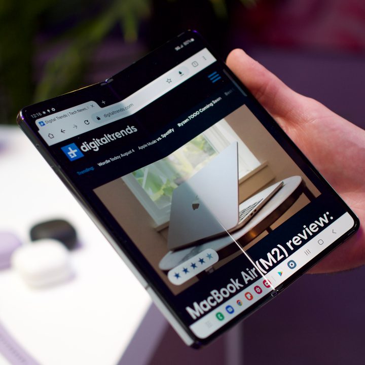 Samsung Galaxy Z Fold 4 opened and being held in one hand.