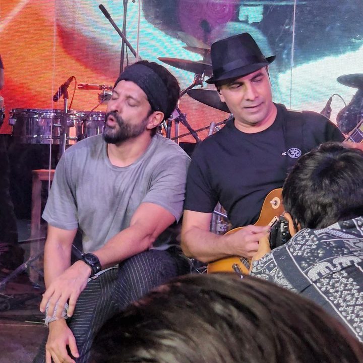 Farhan Akhtar with the guitarist in a concert