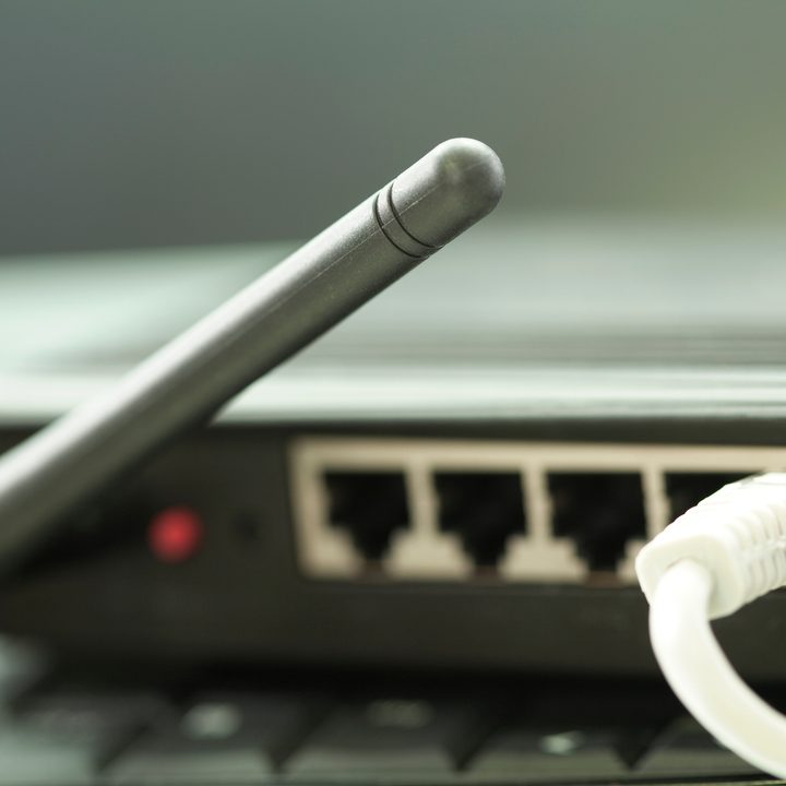 A Wi-Fi router with an ethernet cable plugged in.