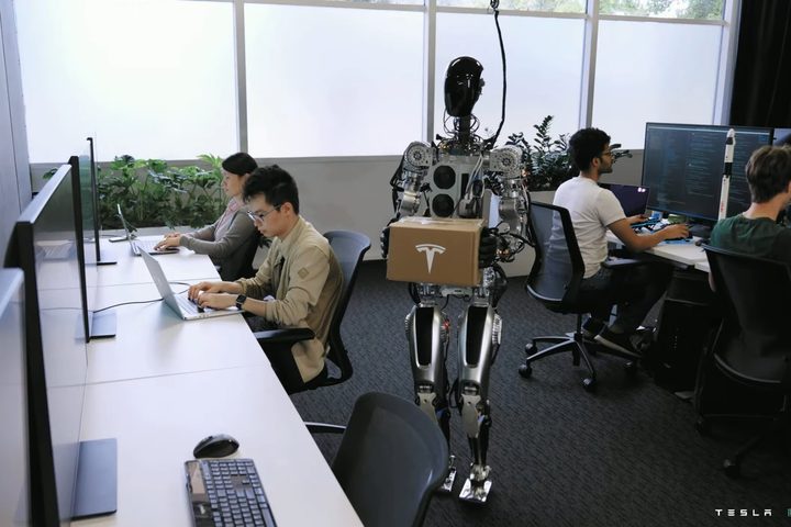 An early, tethered version of the Optimus prototype could deliver a box to a desk.