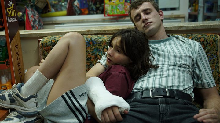 Frankie Corio and Paul Mescal sit together on a couch.