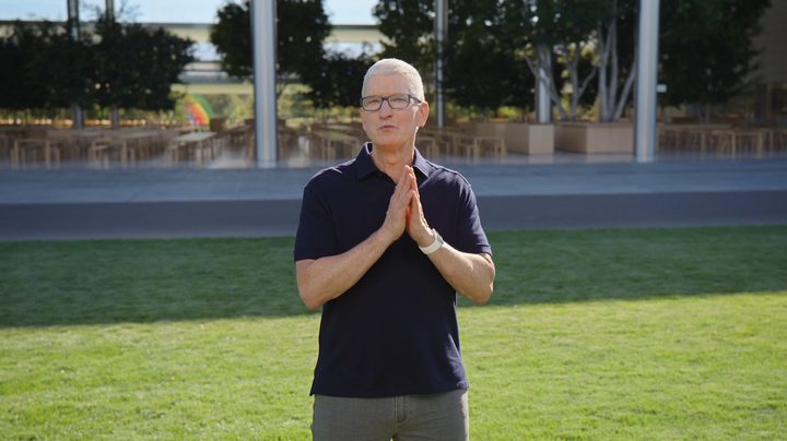 Tim Cook during an Apple presentation on a grass field.
