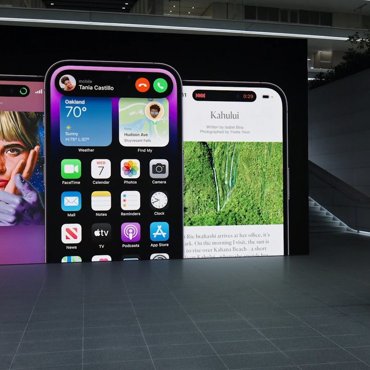 Three iPhone 14 Pro models showing the Dynamic Island, being presented by Apple's Alan Dye.