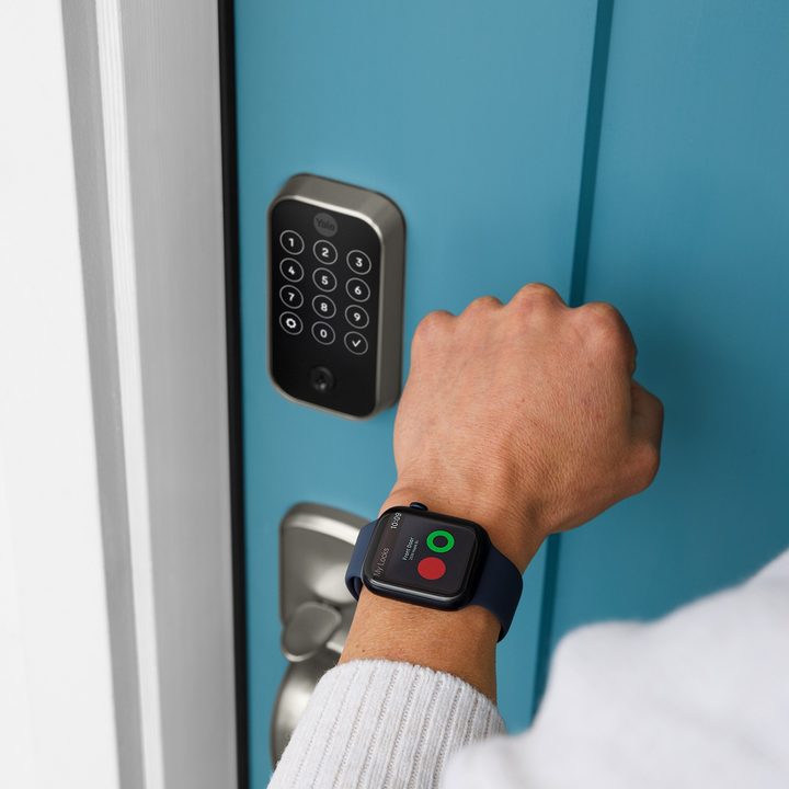 A person checking the Assure Lock 2 status using their smartwatch.