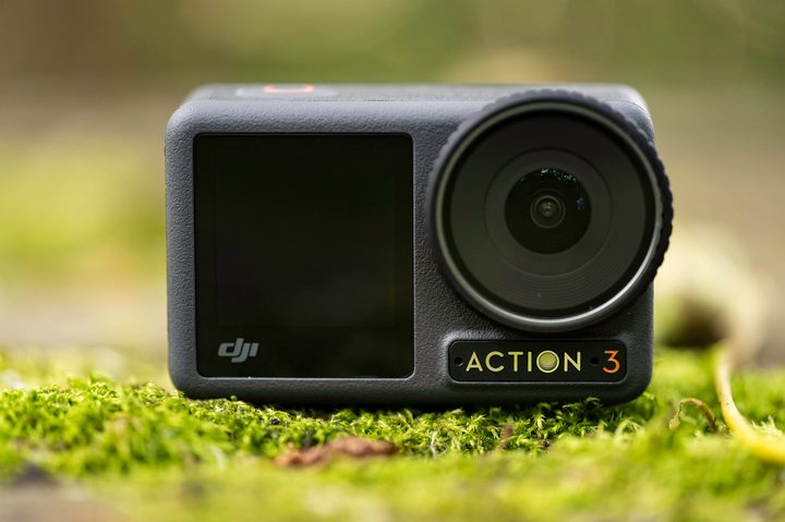 The DJI Osmo Action 3 on a mossy picnic table.