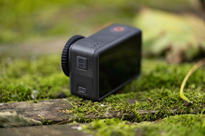 The DJI Osmo action 3 on a mossy picnic table.