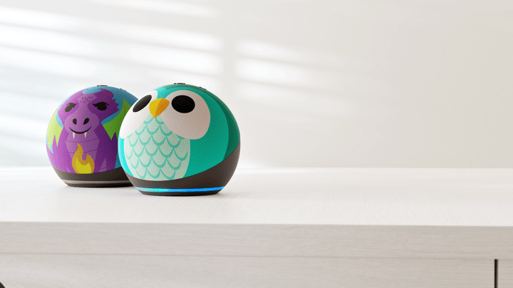 The Echo Dot Kids Owl and Dragon designs on a table.