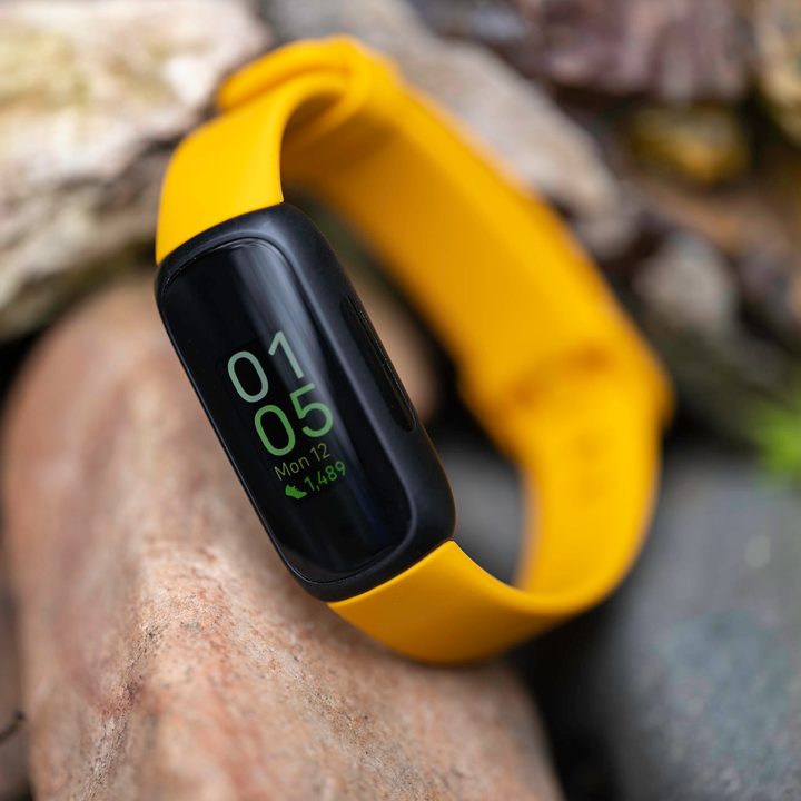 The Fitbit Inspire 3 on a rock.
