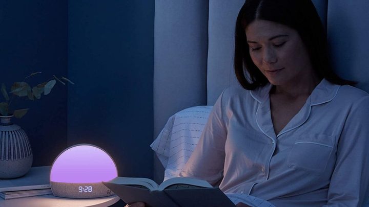 The Hatch Restore glowing purple on a nightstand.