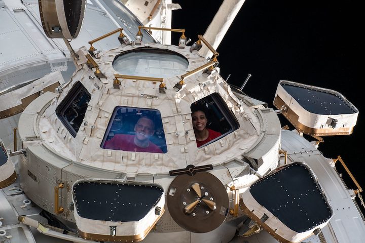 Two astronauts inside the space station's Cupola module.