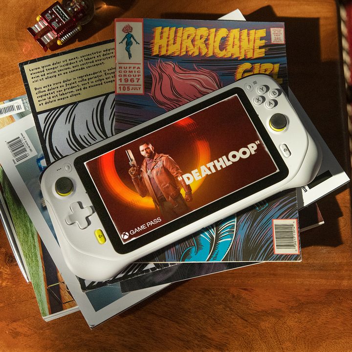 The Logitech G Cloud Gaming Handheld sits on a stack of comics.