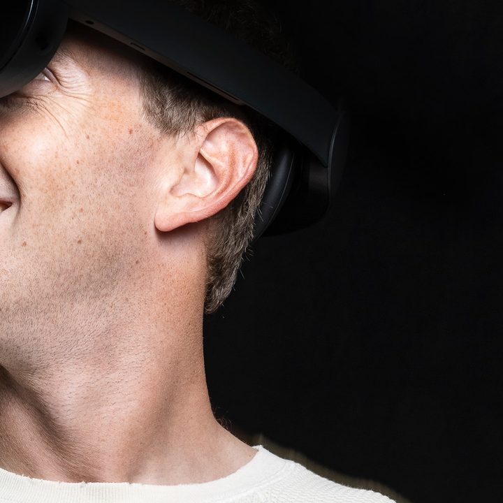 Mark Zukerberg is wearing a next generation VR headset.