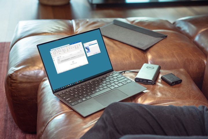 A Dell laptop connected to a hard drive on a couch.
