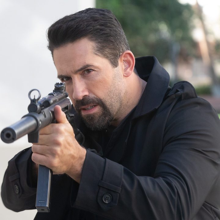 Scott Adkins points a gun in a scene from Section 8.