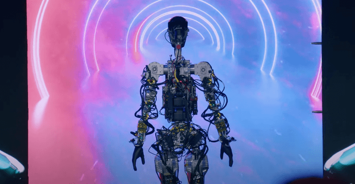 The Tesla Bot, Optimus, on a stage.