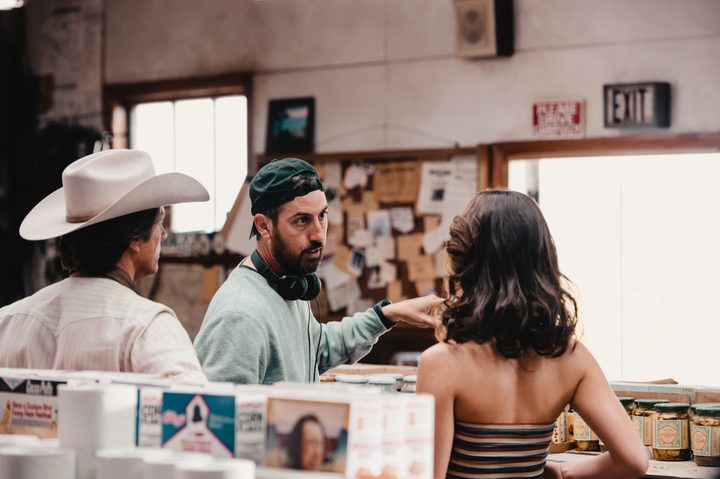 Ti West stands in between Martin Henderson and Mia Goth on the set of X.