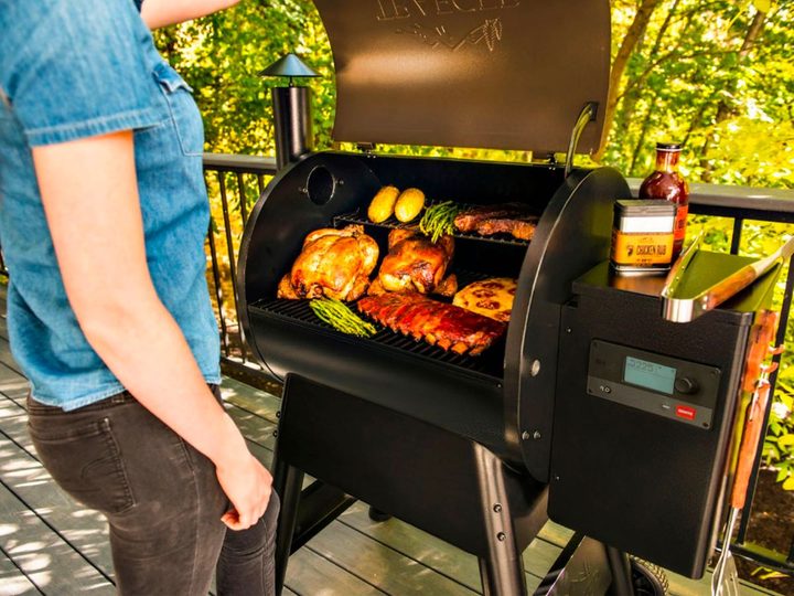A woman grills on the Traeger Grills Pro 575 woodfire grill.