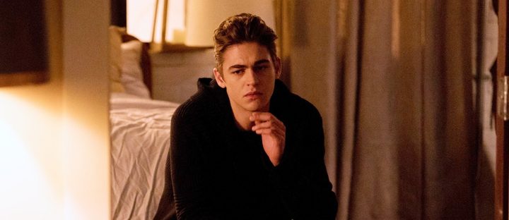 Hardin sits on a bed in After Ever Happy.