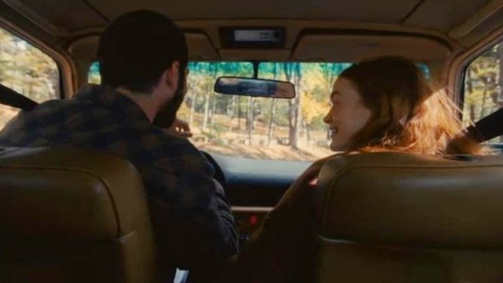 A man and a woman in a car in All Too Well.