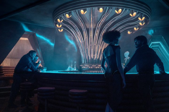 Diego Luna talks to a character in a bar in a scene from Andor.