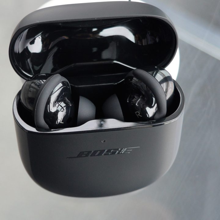 Bose QuietComfort Earbuds II sit in their case.