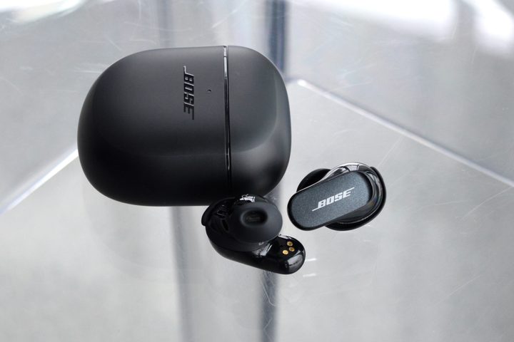 Bose QuietComfort Earbuds II beside charging case.