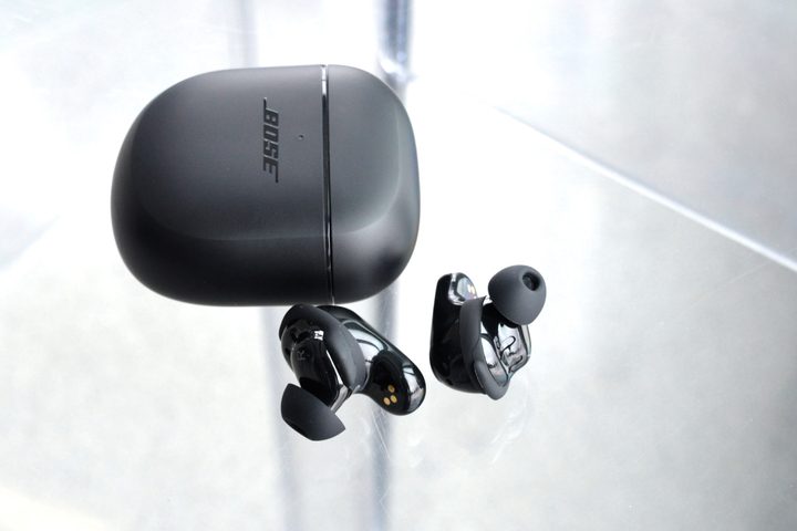 Bose QuietComfort Earbuds II beside charging case.
