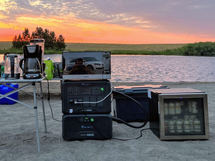 Appliances and a Bluetti AC500 power station stacked on a beach.