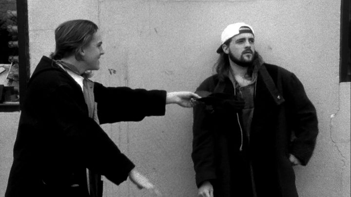 Jay and Silent Bob stand near a wall in Clerks.