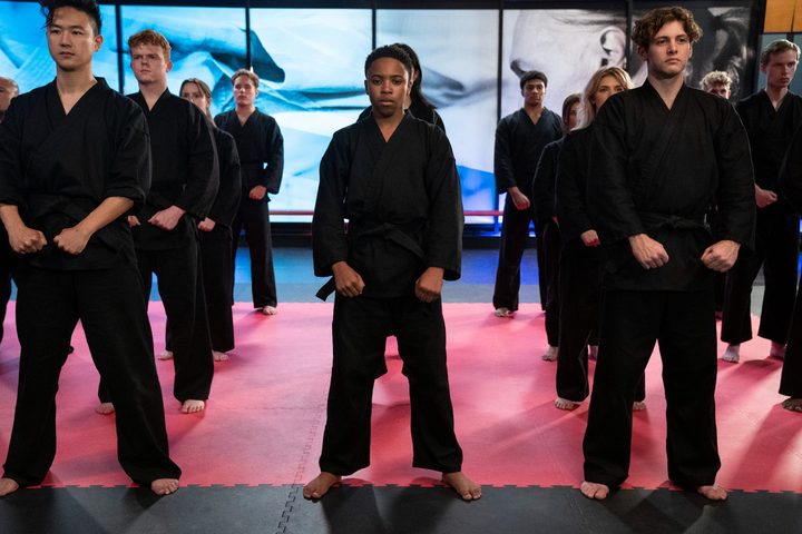 The students of Cobra Kai face the camera in a scene from season 5.