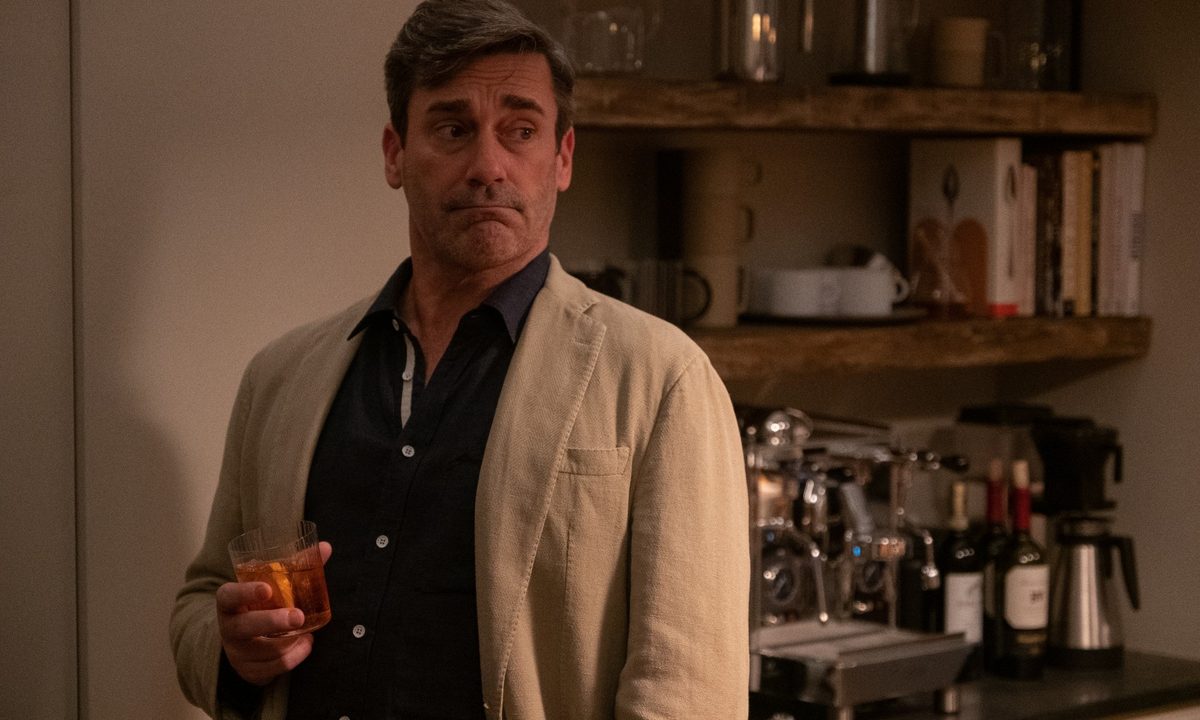 Jon Hamm holds a drink in a scene from Confess, Fletch.