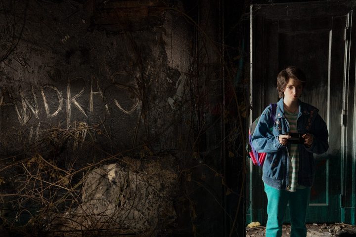 Elsie Fisher walks through a creepy house in a scene from My Best Friend's Exorcism.