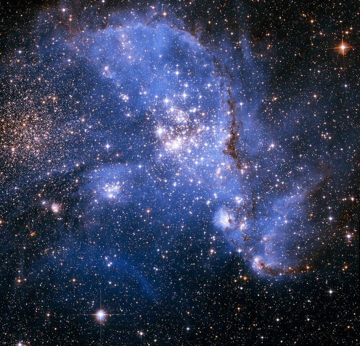 Astronomers have been bemused to find young stars spiralling into the centre of a massive cluster of stars in the Small Magellanic Cloud, a satellite galaxy of the Milky Way. The outer arm of the spiral in this huge, oddly shaped stellar nursery — called NGC 346 — may be feeding star formation in a river-like motion of gas and stars. This is an efficient way to fuel star birth, researchers say.