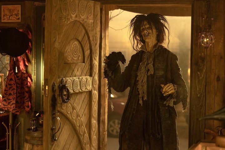 Doug Jones as the zombified Billy Butcherson opens a door in a scene from Hocus Pocus 2.