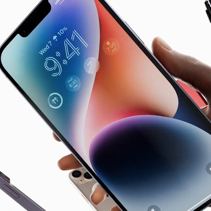 iPhone 14 Plus in hand.