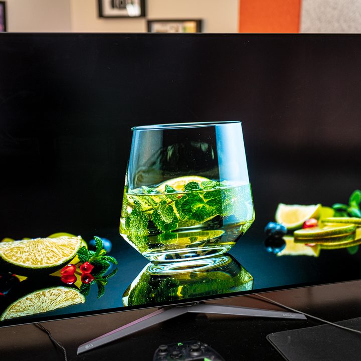 A still from a video of a cup of water with mint surrounded by cut fruit on the UltraGear 48-inch OLED.