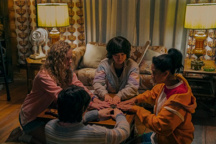 A group of girls gathers around a Ouija board in My Best Friend's Exorcism.