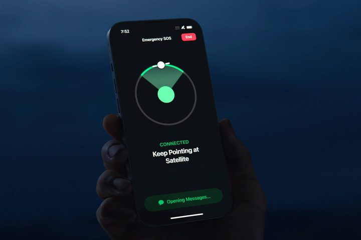 Person holding iPhone 14 searching for Emergency SOS satellite.