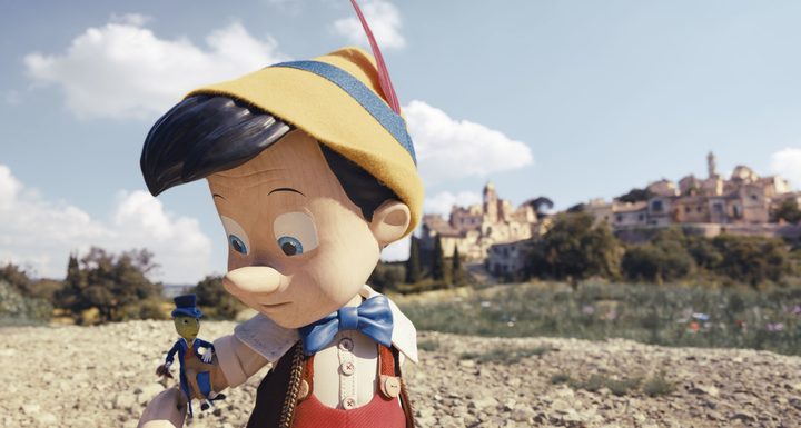 Pinocchio looks at Jiminy Cricket in a scene fro the 2022 live-action film.