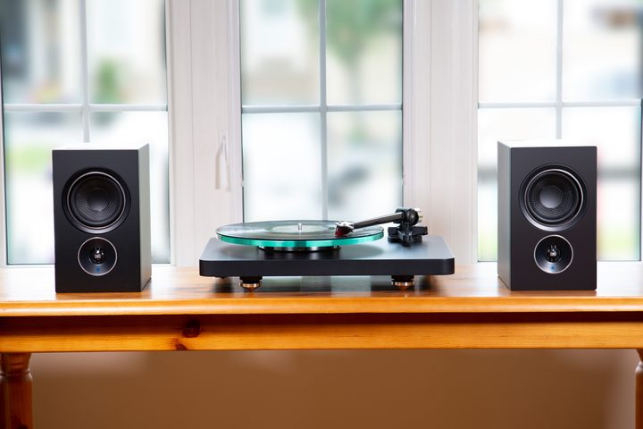 The PSB Alpha iQ Streaming Powered Speakers with a turntable.