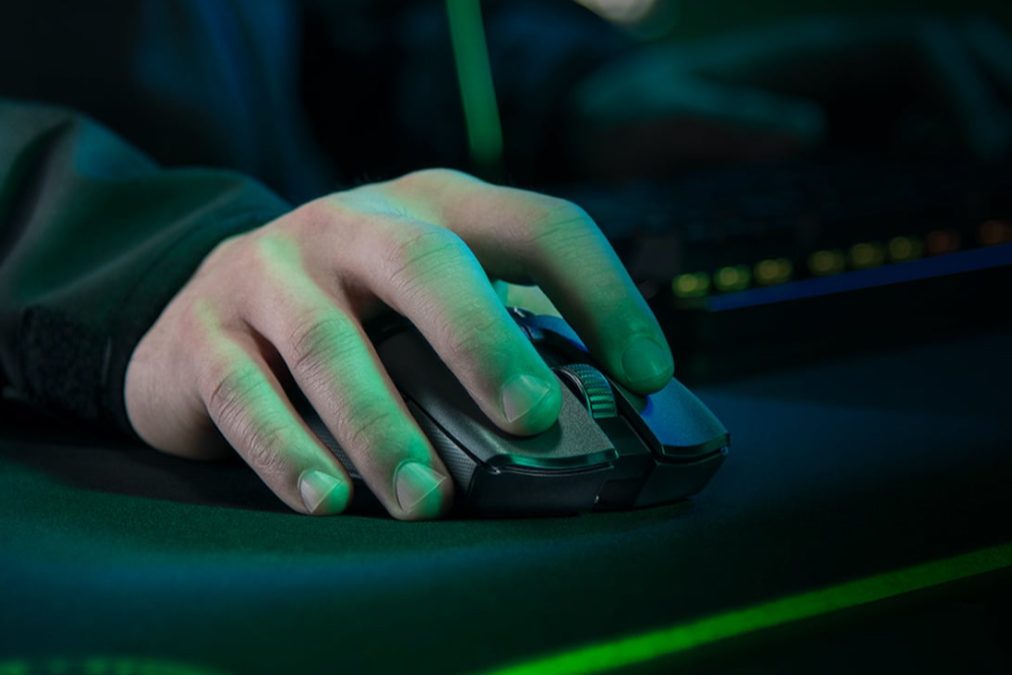 The Razer Viper Ultimate gaming mouse with a hand on top.