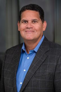 A close up headshot of former Nintendo of America president Reggie Fils-Aime